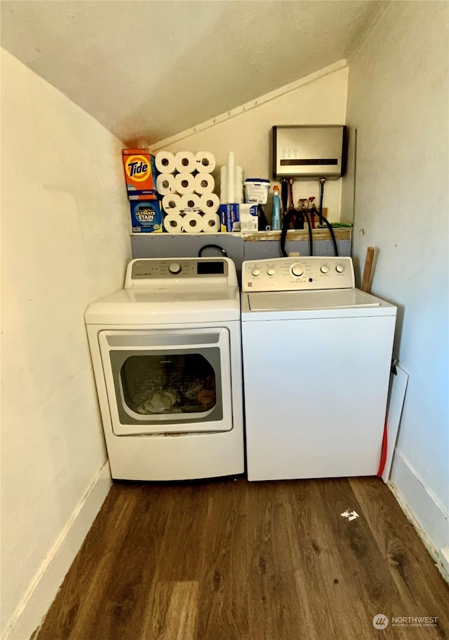 washroom with dark wood-type flooring and washing machine and dryer