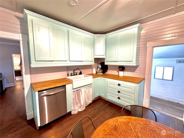 kitchen featuring wood walls, wood counters, sink, dark wood-type flooring, and stainless steel dishwasher