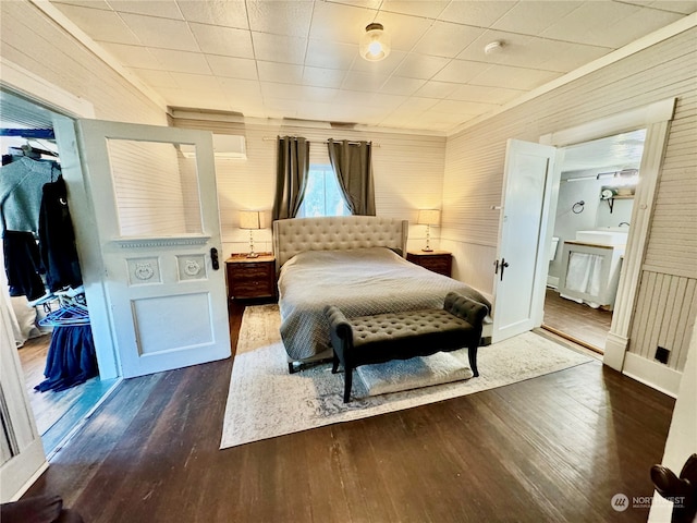 bedroom with dark wood-type flooring