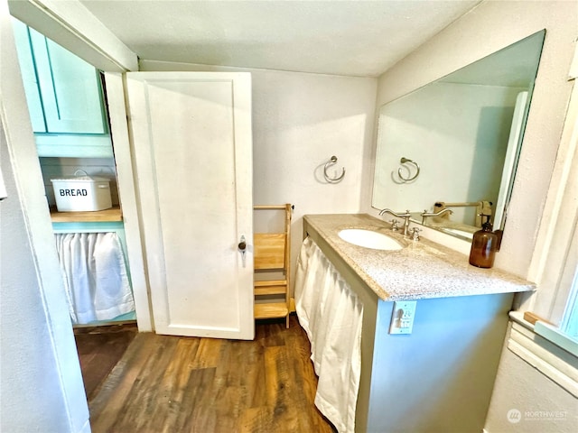 bathroom with vanity and wood-type flooring