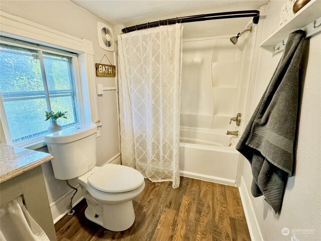 full bathroom with vanity, toilet, shower / tub combo with curtain, and hardwood / wood-style floors