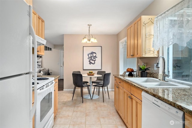 kitchen with light brown cabinetry, sink, decorative light fixtures, a chandelier, and white appliances