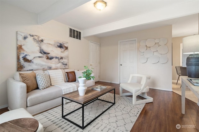 living room featuring beamed ceiling and light wood-type flooring