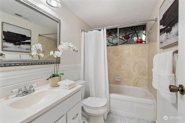 full bathroom featuring vanity, shower / bath combo, and toilet