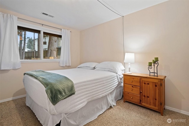 bedroom featuring light carpet