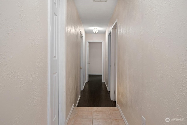 corridor featuring light tile patterned floors