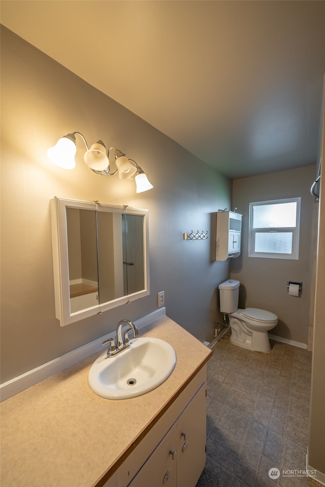 bathroom featuring toilet and vanity