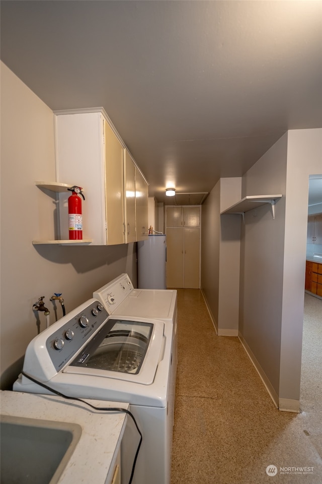 laundry area featuring cabinets, independent washer and dryer, and water heater