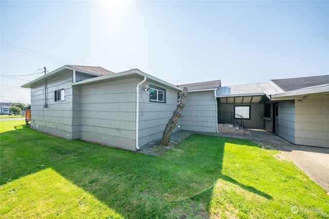 rear view of house featuring a yard