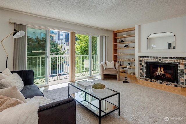 living room featuring a textured ceiling and a tiled fireplace