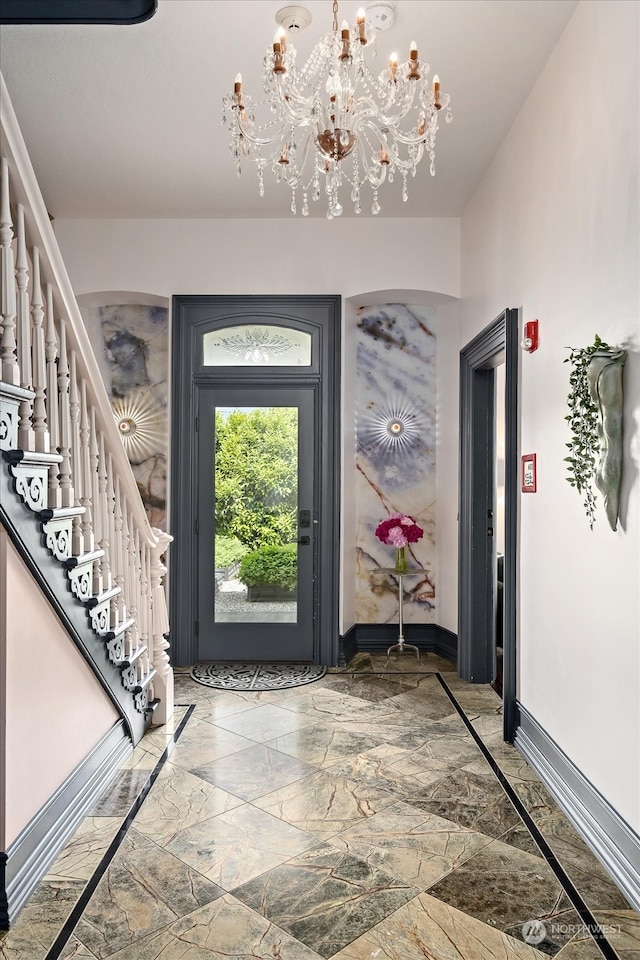 entryway with a chandelier