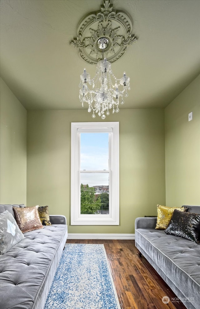 living room featuring dark hardwood / wood-style flooring and a notable chandelier