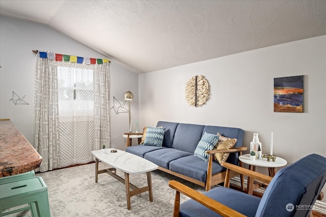 living room with lofted ceiling, carpet floors, and a textured ceiling