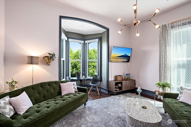 living room with a notable chandelier and dark hardwood / wood-style flooring