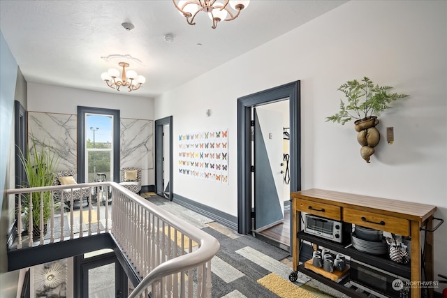 corridor featuring an inviting chandelier and wood-type flooring