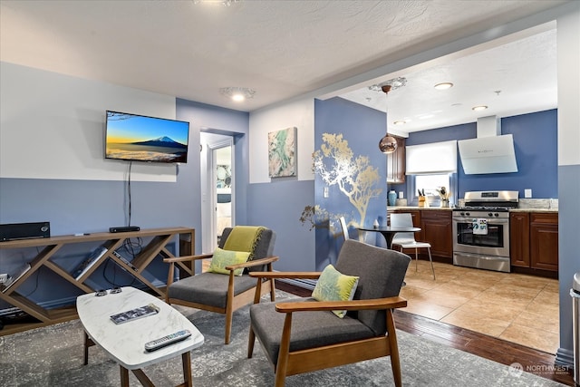 living room featuring light wood-type flooring and a textured ceiling