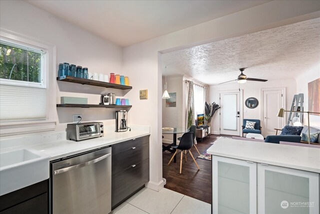 kitchen with a textured ceiling, dishwasher, ceiling fan, and light hardwood / wood-style floors