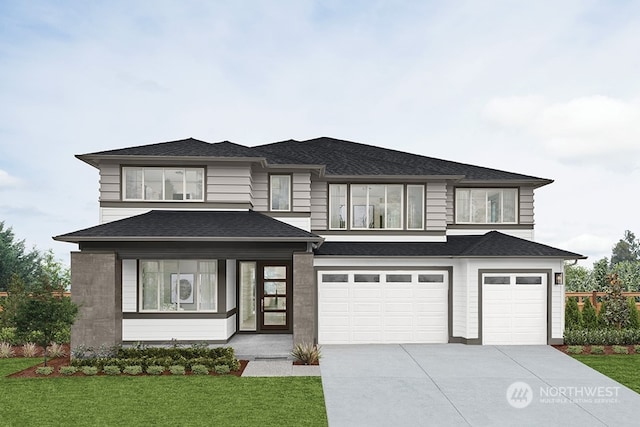 prairie-style house featuring an attached garage, concrete driveway, a front lawn, and roof with shingles