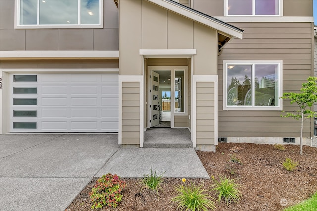 doorway to property with a garage