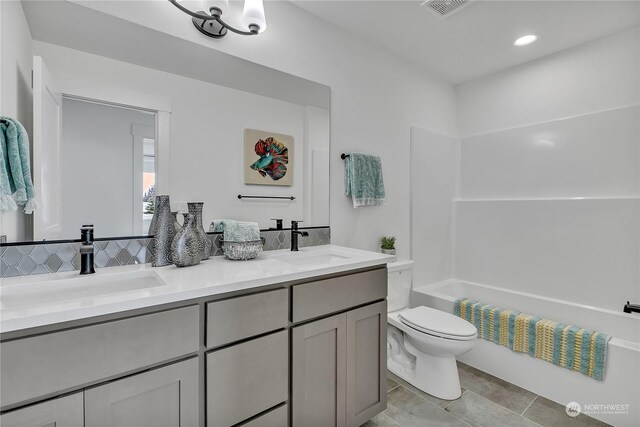 full bathroom featuring vanity, tile patterned floors, toilet, and shower / bath combination