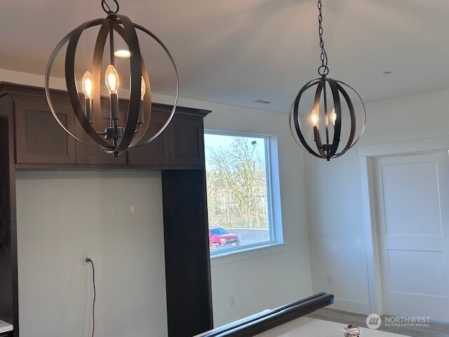 interior details with baseboards and a chandelier