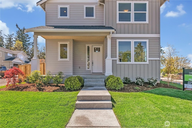 16212 76th Avenue Ct E, Puyallup, WA 98375 - view of front facade with fence, board and batten siding, and a front yard