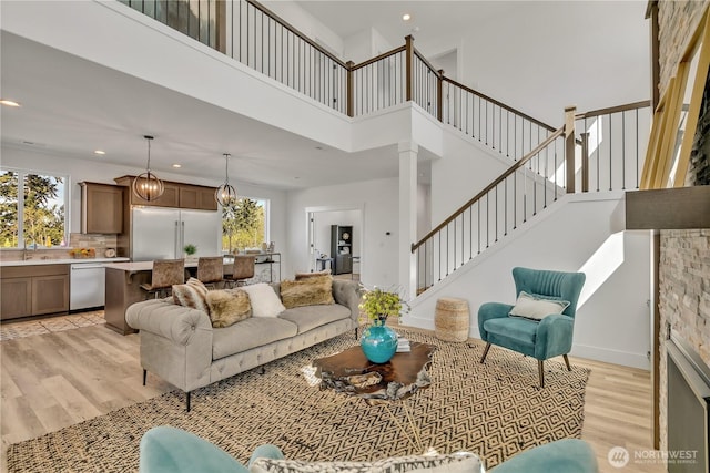 16212 76th Avenue Ct E, Puyallup, WA 98375 - living area featuring light wood-style flooring, a high ceiling, recessed lighting, and stairway