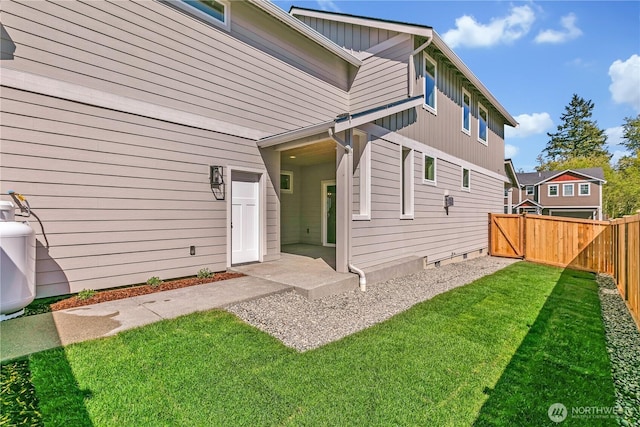 16212 76th Avenue Ct E, Puyallup, WA 98375 - back of house featuring a lawn and a fenced backyard