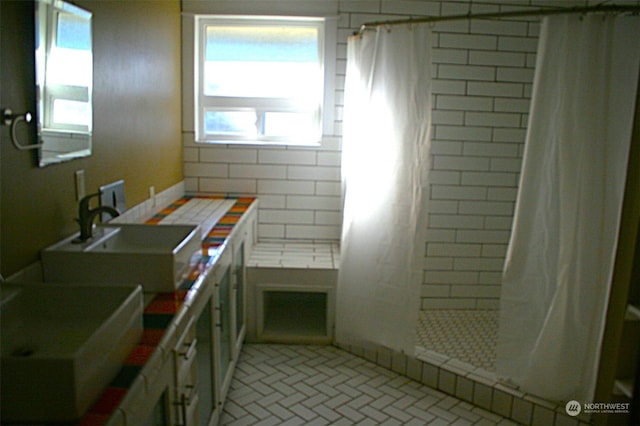 bathroom featuring a shower with shower curtain and sink