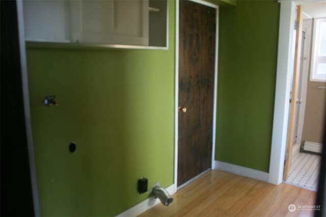 laundry room with light hardwood / wood-style flooring