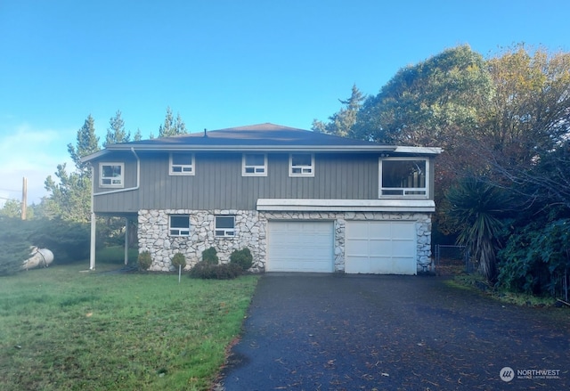 view of front property with a garage and a front yard