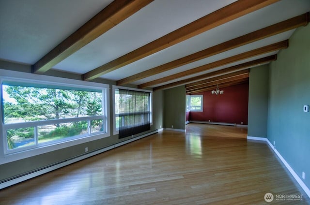 empty room with baseboards, lofted ceiling with beams, a baseboard radiator, wood finished floors, and a chandelier