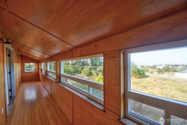 unfurnished sunroom featuring lofted ceiling and wooden ceiling