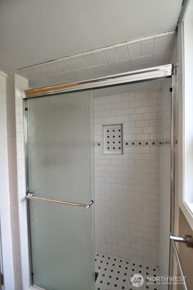 bathroom featuring a shower stall