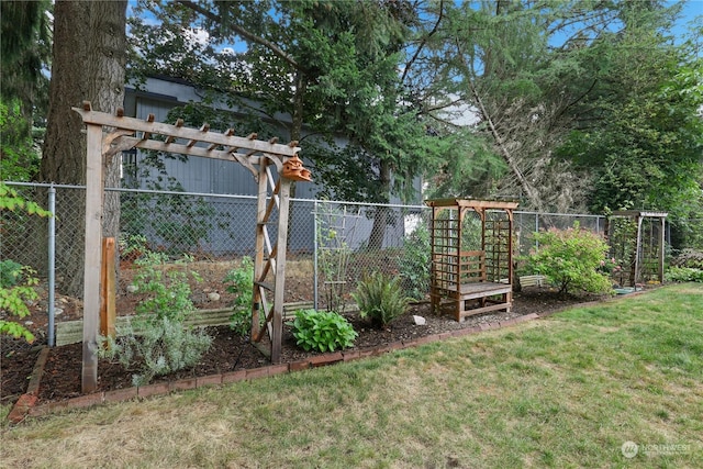 view of yard featuring a vegetable garden and fence