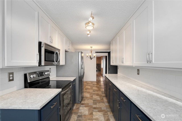 kitchen featuring appliances with stainless steel finishes, white cabinetry, and blue cabinets