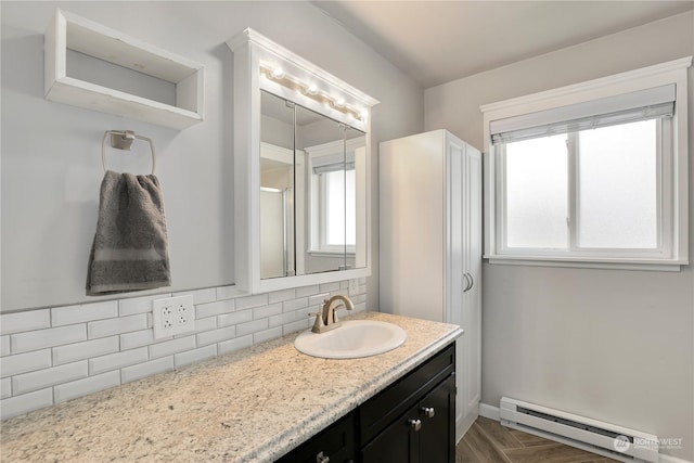 bathroom with baseboard heating, backsplash, and vanity