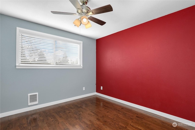 unfurnished room featuring visible vents, baseboards, wood finished floors, and a ceiling fan