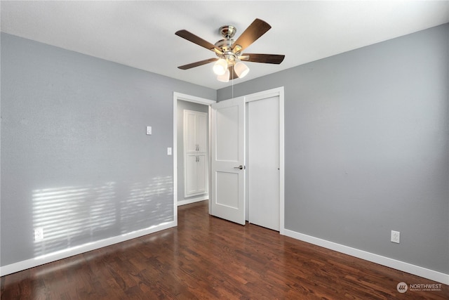 empty room with ceiling fan, baseboards, and wood finished floors