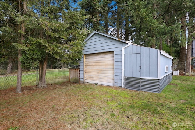 detached garage with driveway and fence