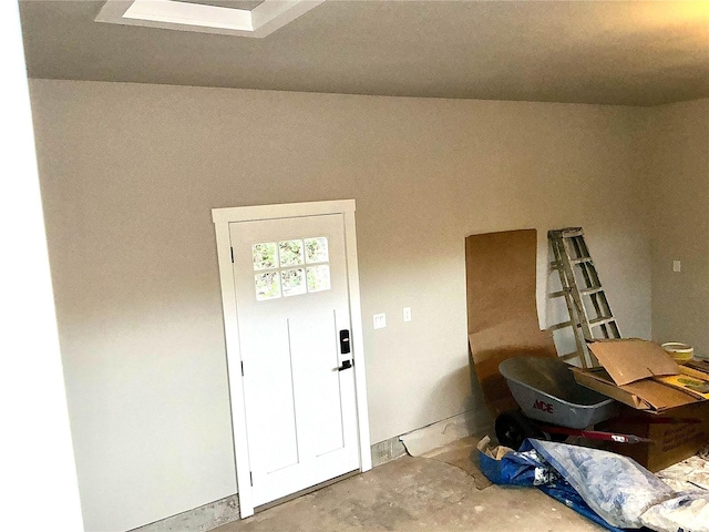 entrance foyer featuring unfinished concrete flooring