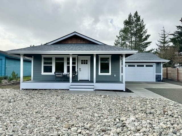 view of front of home featuring covered porch and a garage