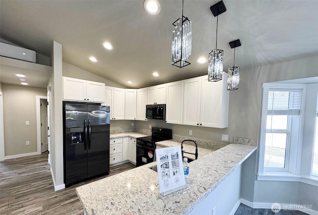 kitchen with light stone counters, a peninsula, black appliances, white cabinets, and vaulted ceiling