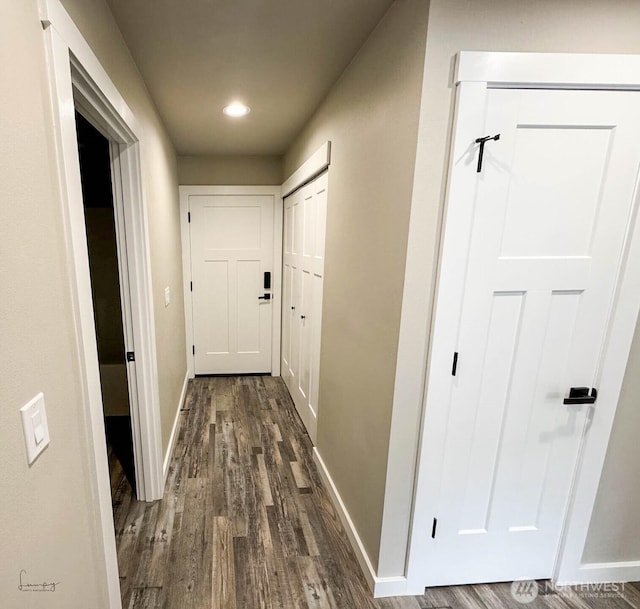 corridor with recessed lighting, baseboards, and dark wood-style flooring