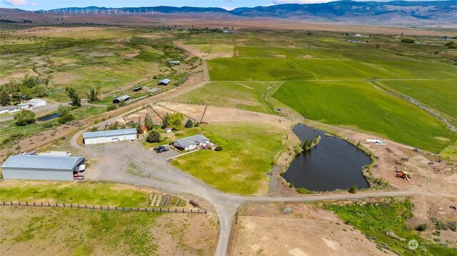 birds eye view of property featuring a rural view and a water and mountain view