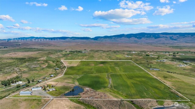 aerial view featuring a rural view and a water and mountain view