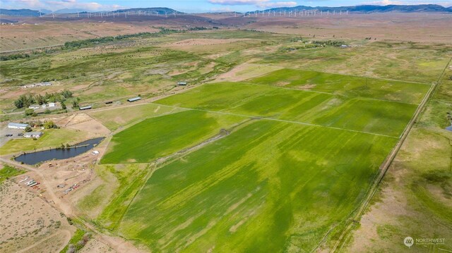 drone / aerial view featuring a water and mountain view and a rural view