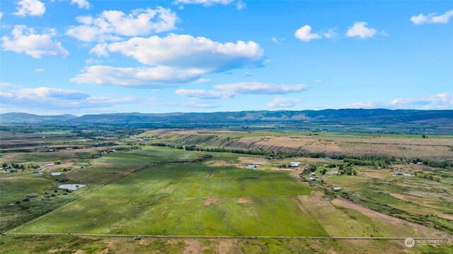 drone / aerial view featuring a mountain view and a rural view