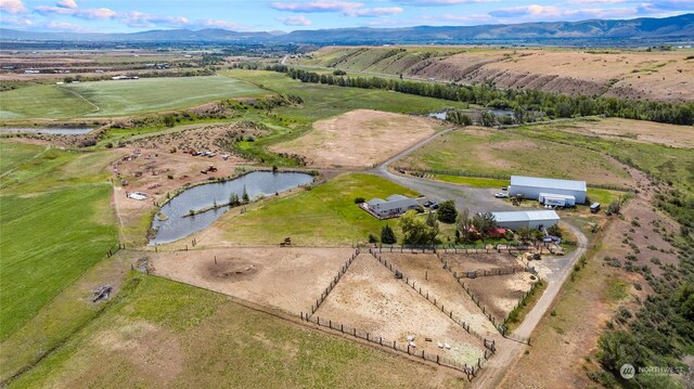 drone / aerial view featuring a water and mountain view and a rural view