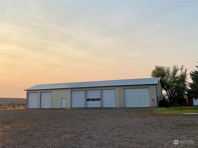 view of garage at dusk